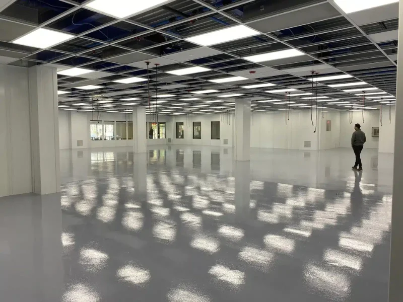 Glossy gray epoxy floor in a large open cleanroom space at High-Purity NE, Smithfield, RI