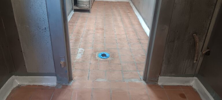 Membrane with fiberglass reinforcement around a floor drain before the basecoat, Brazilian Grill, Hyannis, MA