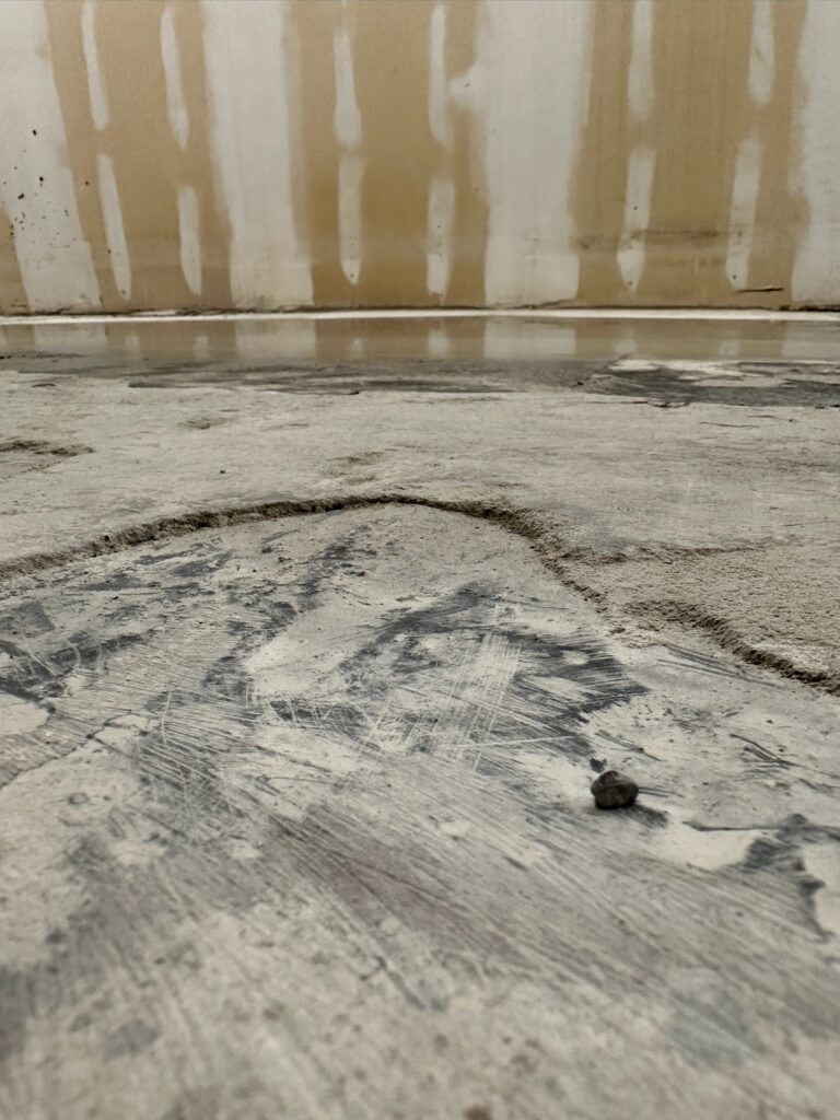 Burlington, Walpole, MA: slab surface with grinding marks during removal of existing layers