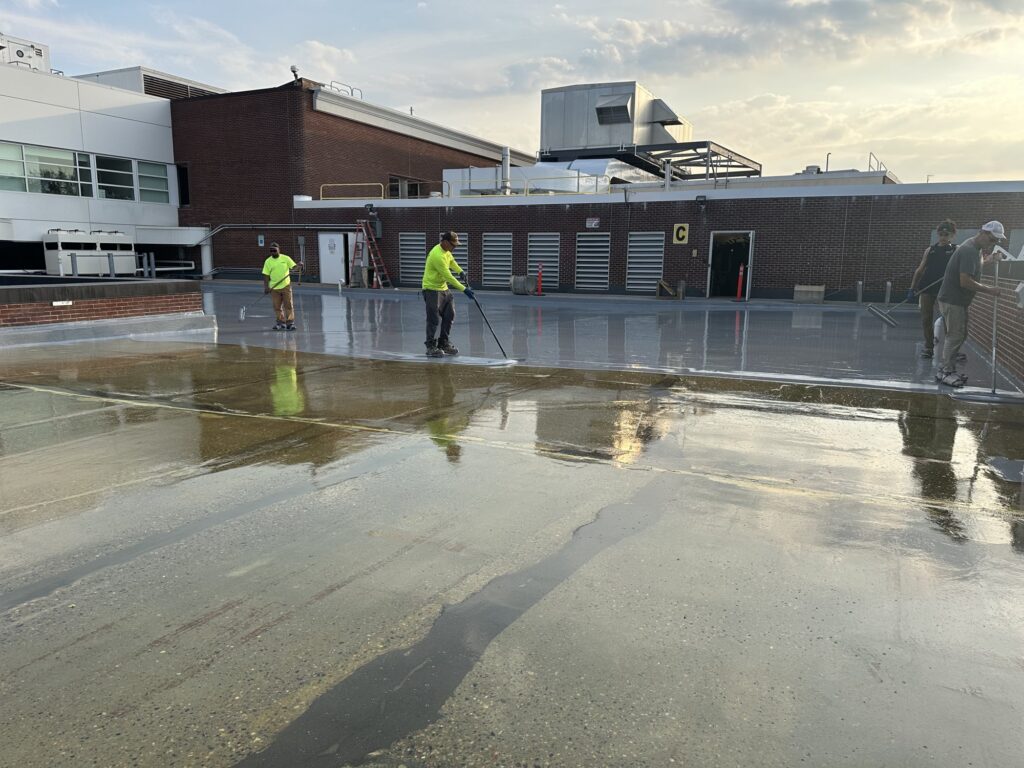 Topcoat crew washing the Cape Cod Hospital parking deck surface during preparation