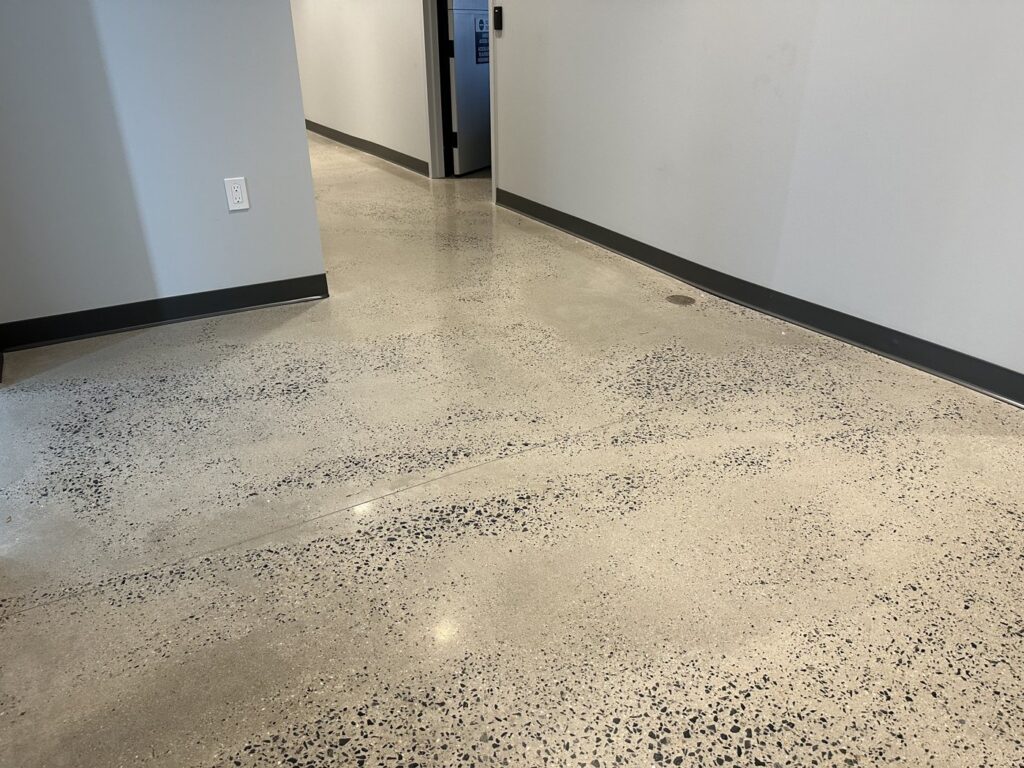 Polished concrete floor with random aggregate exposure in a corridor