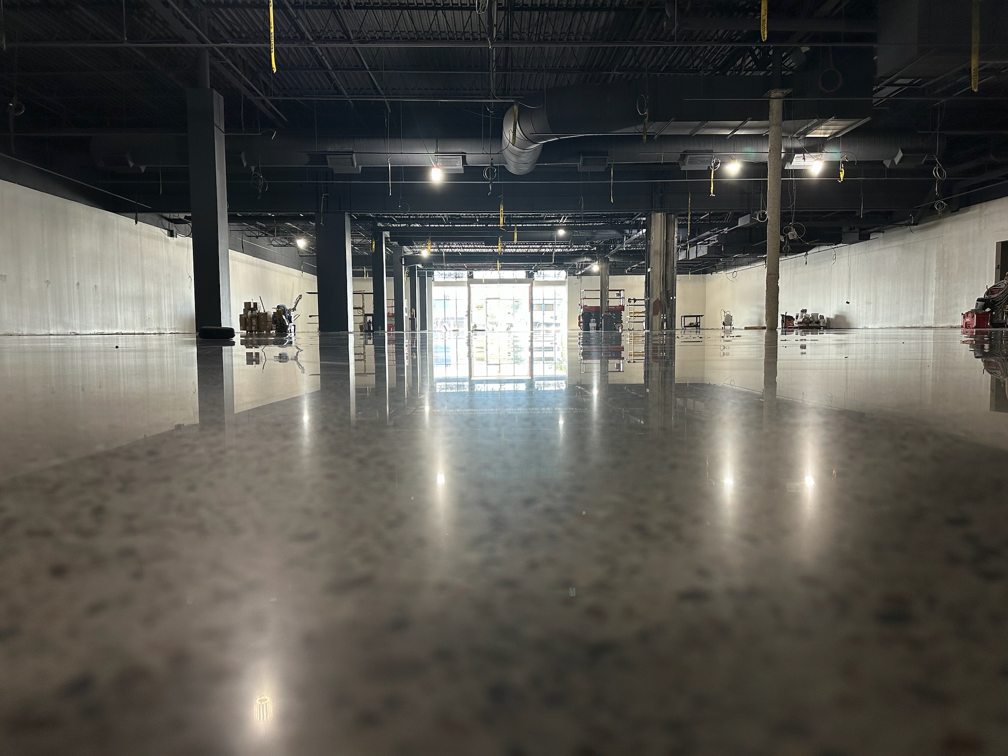 Retail & Grocery Flooring 11 Completed polished concrete floor in an empty store looking toward the storefront entrance at the L.L. Bean Outlet, Framingham, MA