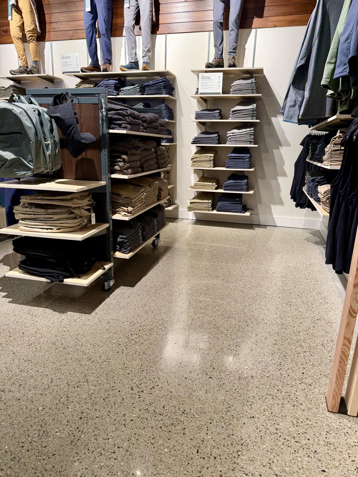 Retail & Grocery Flooring 1 Polished concrete floor beside merchandise shelving and hanging apparel at the L.L. Bean Outlet, Framingham, MA