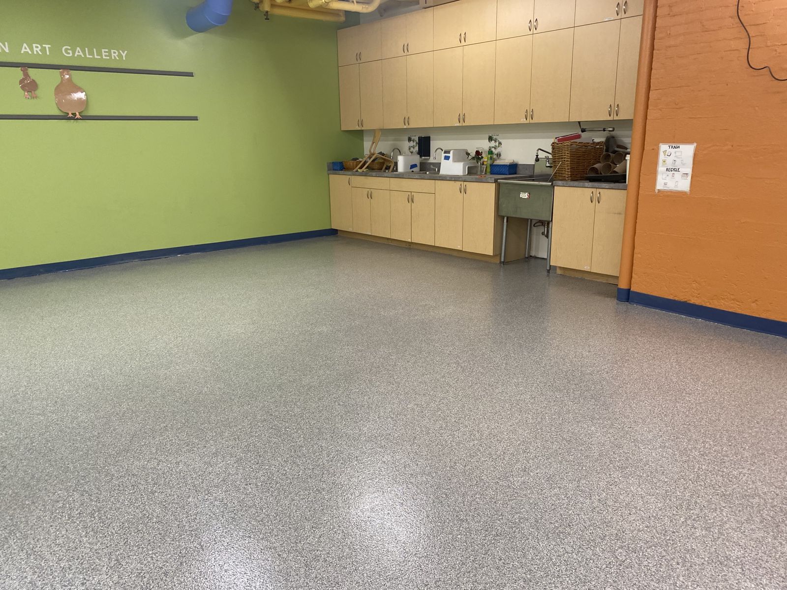 Flooring for Schools & Universities 10 Art room with a gray decorative flake floor, light wood cabinets, a utility sink and a blue cove base, private school in Newton, MA
