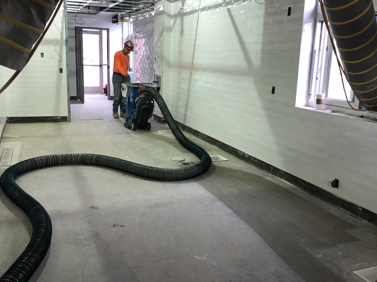 prep crew grinding corridor 2 concrete repair