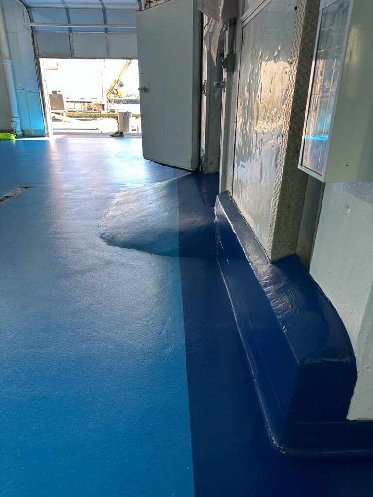 Two-tone blue floor and dark blue curb at a cooler door, Rocky Neck, Boston Fish Pier