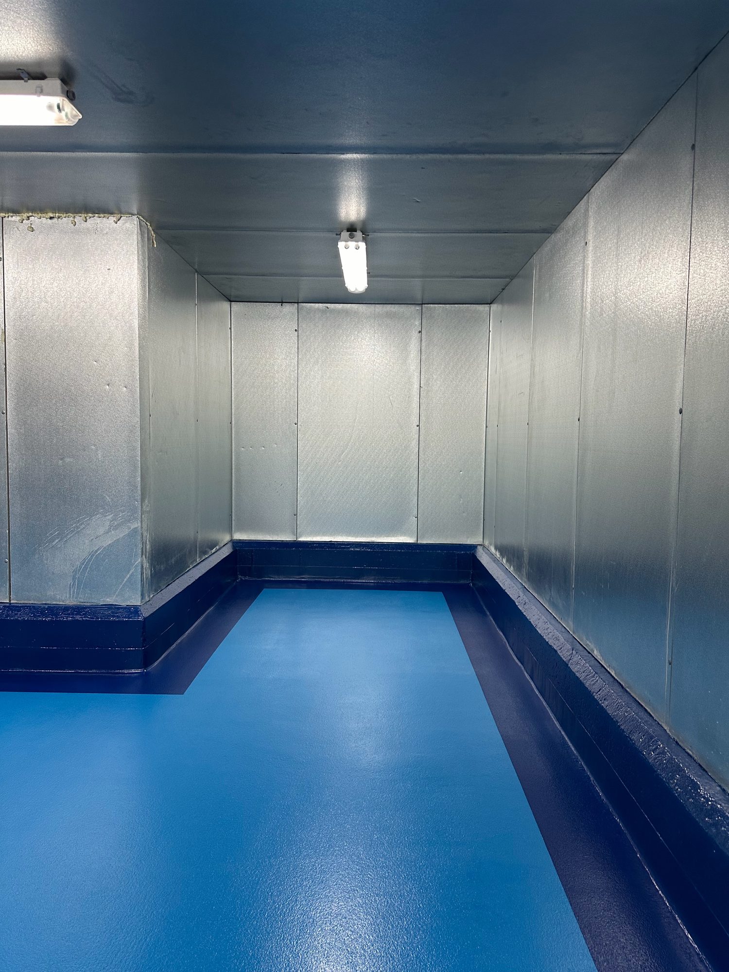 Two-tone blue floor with dark blue cove base in a walk-in cooler, Rocky Neck Fish, Boston Fish Pier, Boston, MA