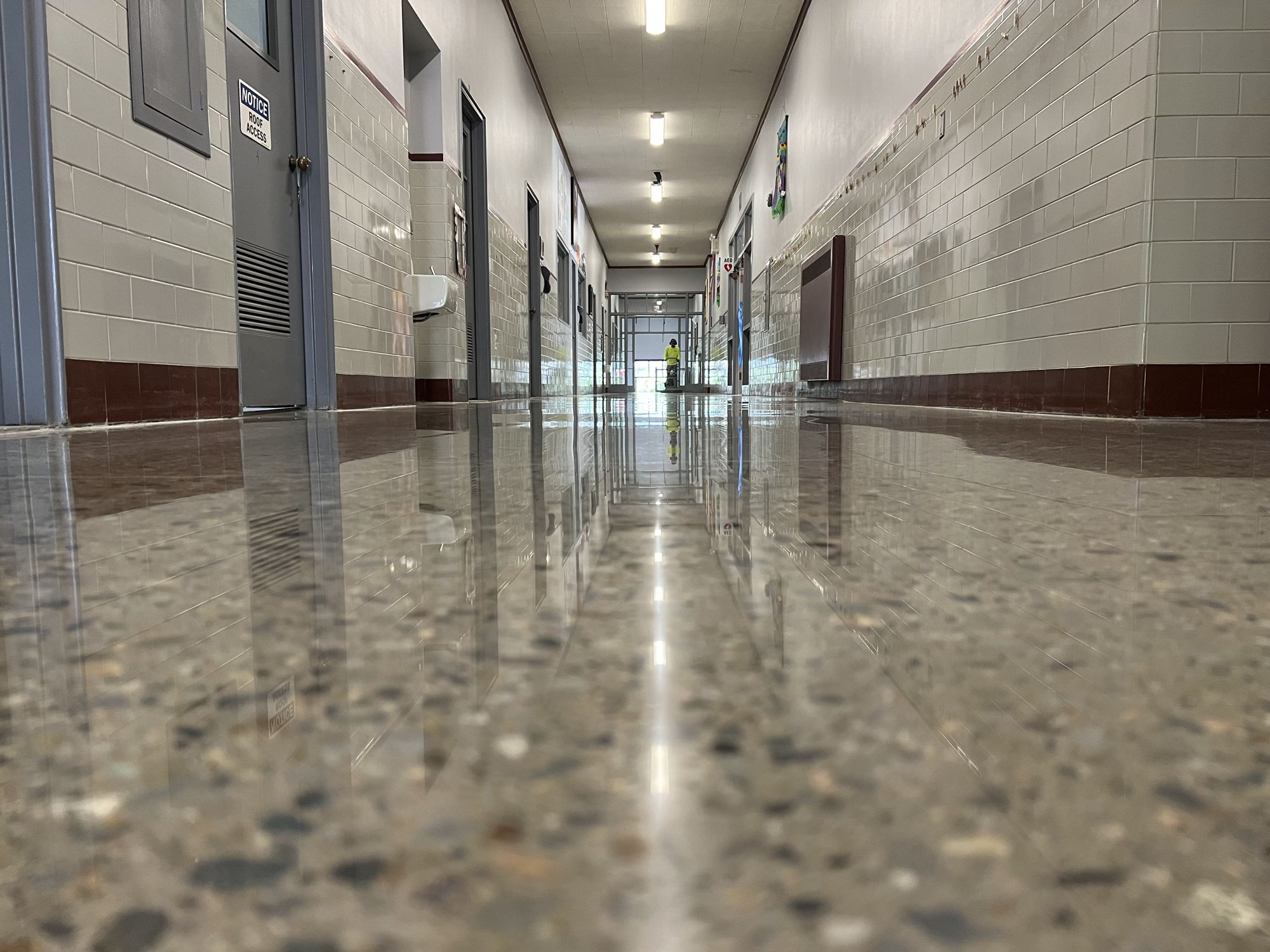 Flooring for Schools & Universities 1 Polished concrete hallway with exposed aggregate and reflected ceiling lights, St. Teresa of Calcutta School, New Bedford, MA
